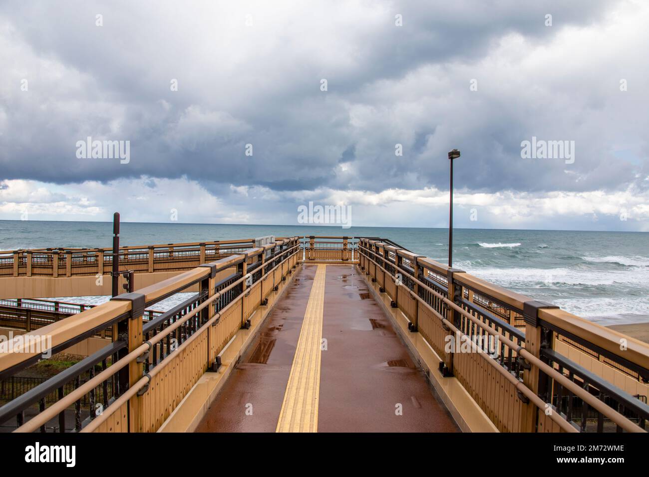 the pedestrian bridge to Hakuto Coast in Tottori Japan. It has a beautiful sandy beach and an impressive view of the ocean stretching to the horizon. Stock Photo