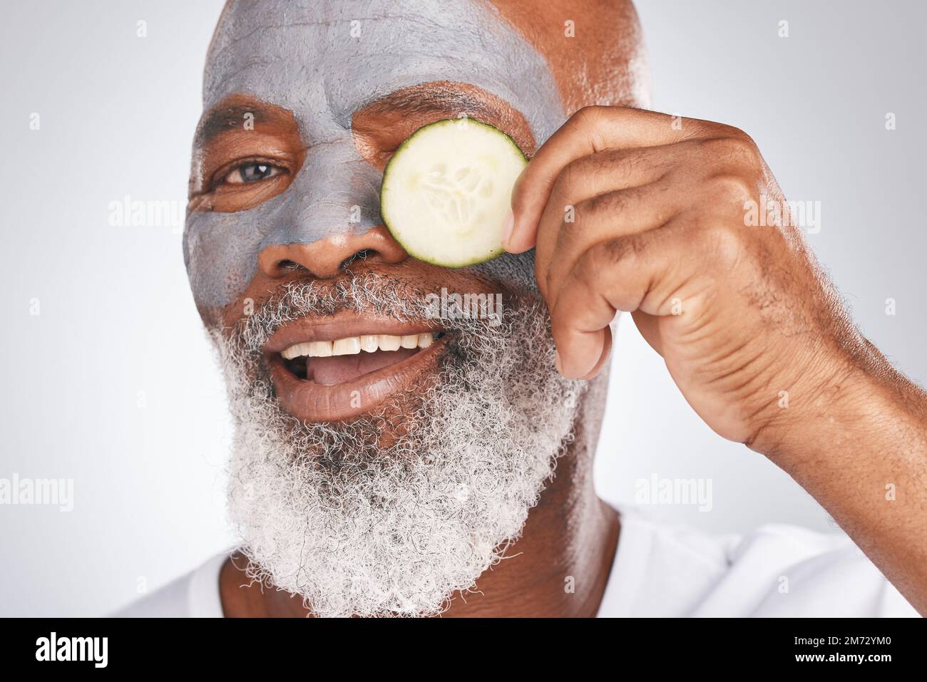 Skincare, face mask or old man portrait with cucumber marketing or advertising natural vegan diet for glowing skin. Cream, happy, senior black man Stock Photo