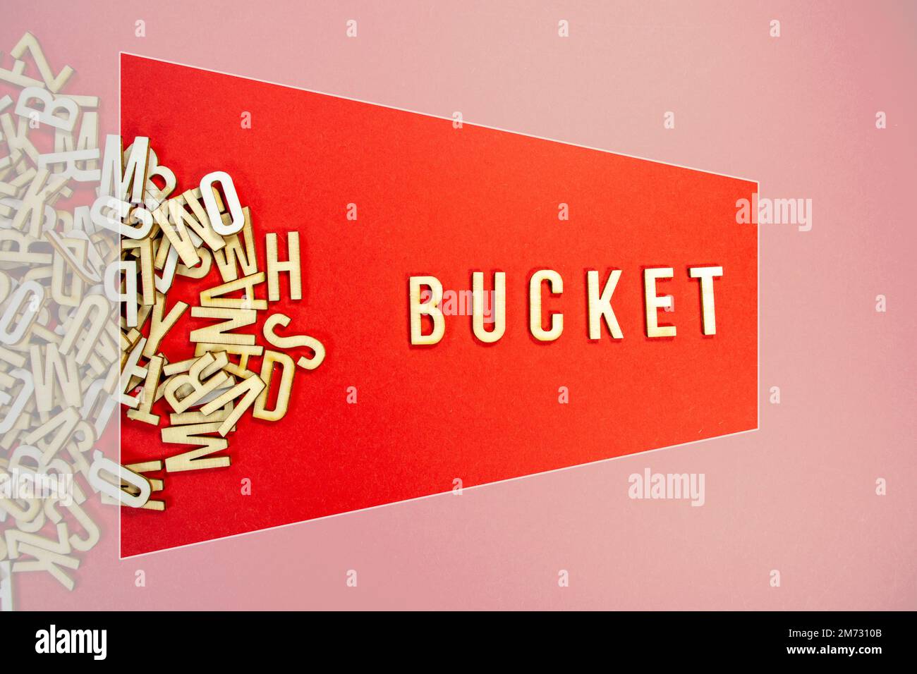 BUCKET in wooden English words language capital letters spilling from a