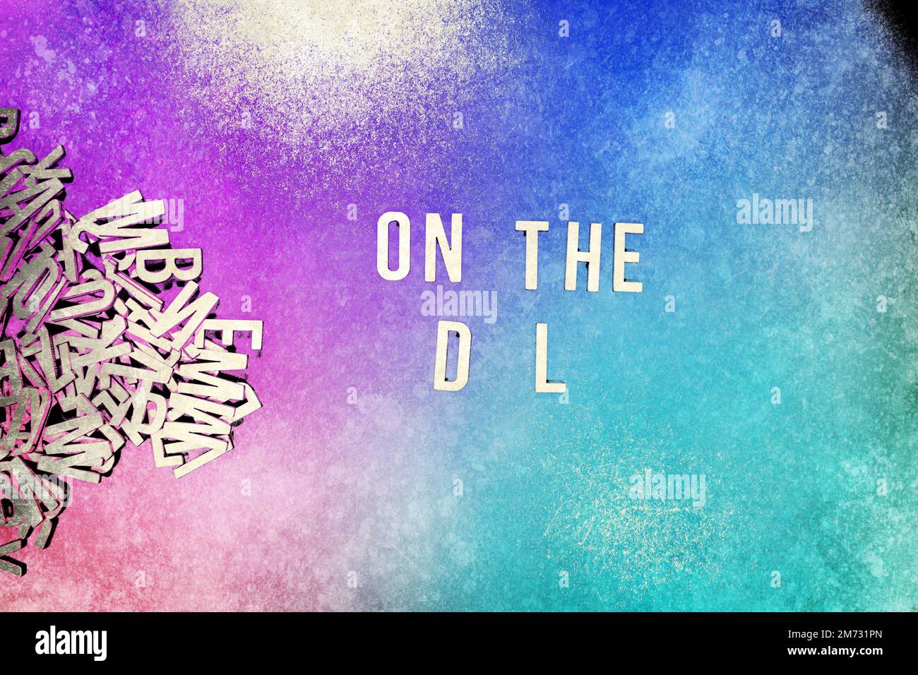 ON THE D L in wooden English language capital letters spilling from a ...