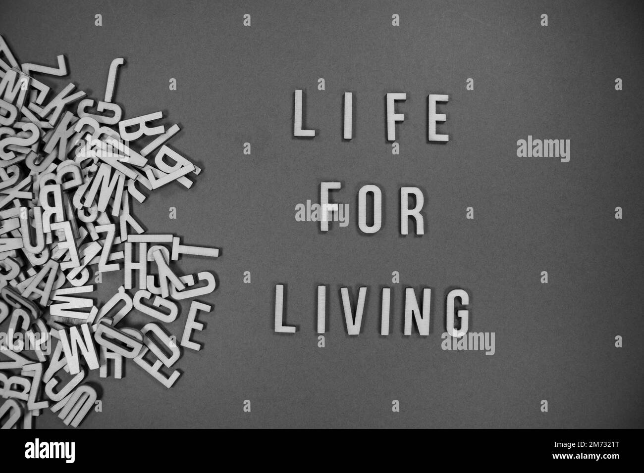 pile of wooden English language capital letters spilling into words