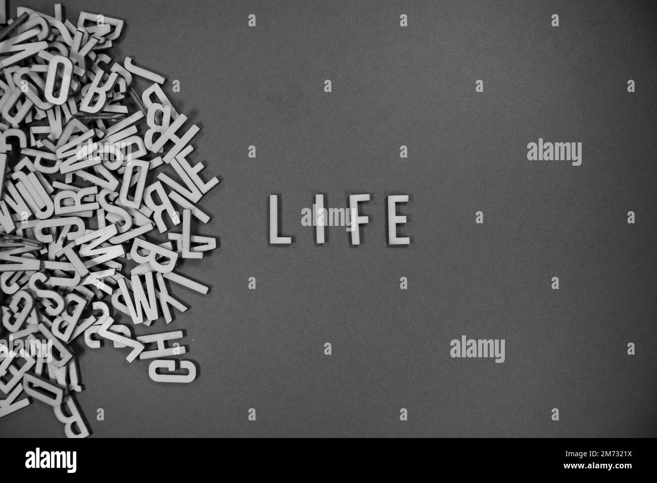 pile of wooden English language capital letters spilling into words