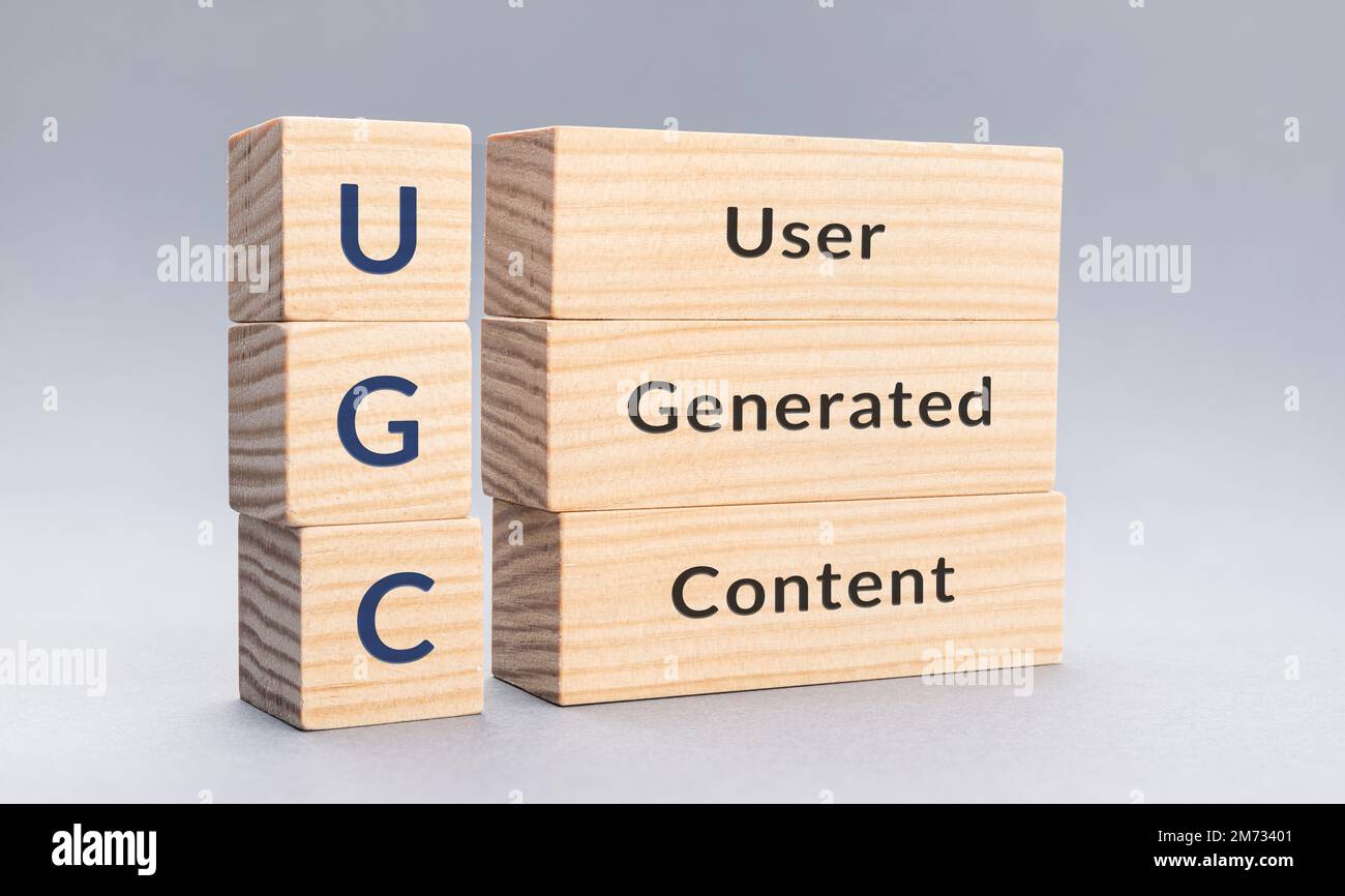 UGC User Generated Content text on wooden blocks on gray background ...