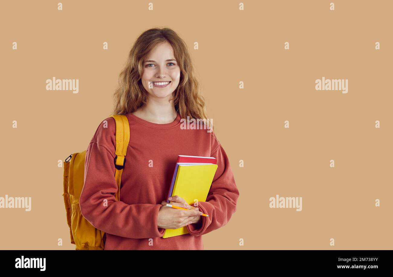 Portrait of happy smiling student girl with backpack and folders on ...