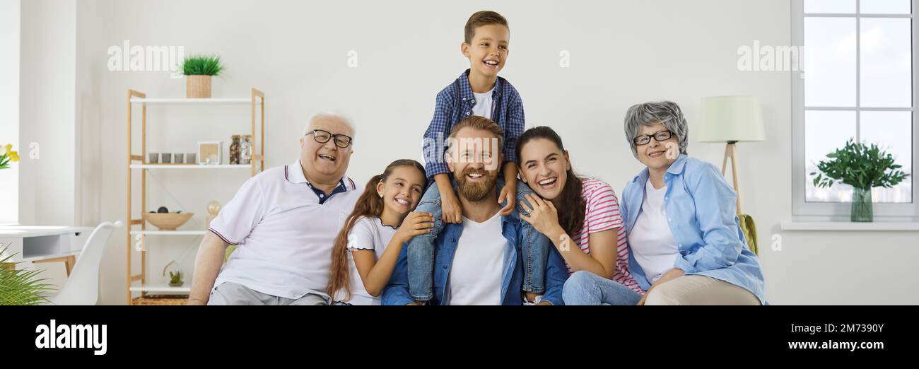 Banner background with group portrait of happy, cheerful family all together at home Stock Photo
