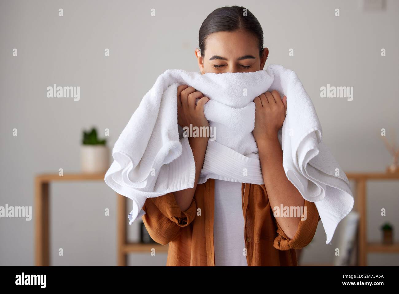 Laundry, fresh and woman smelling a towel after cleaning, housework and