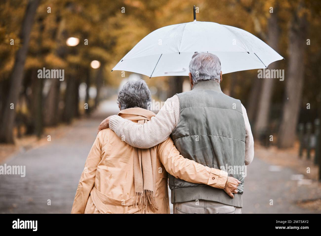 Elderly, couple walk in park with umbrella and fresh air, outdoor in