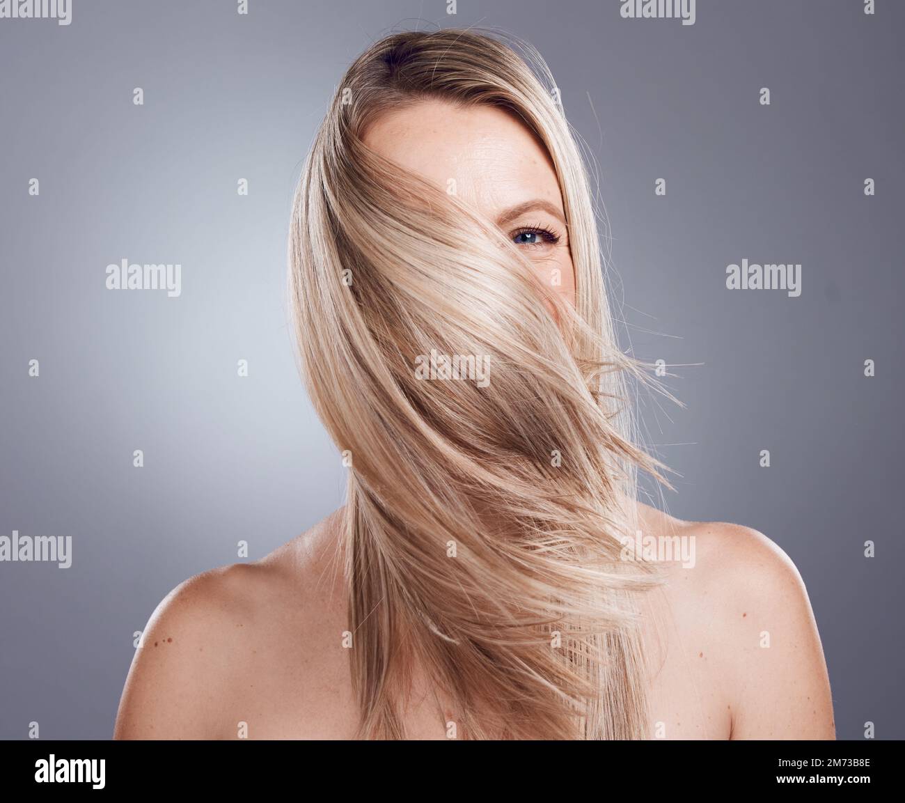 Woman portrait blonde or windy hairstyle on studio background for