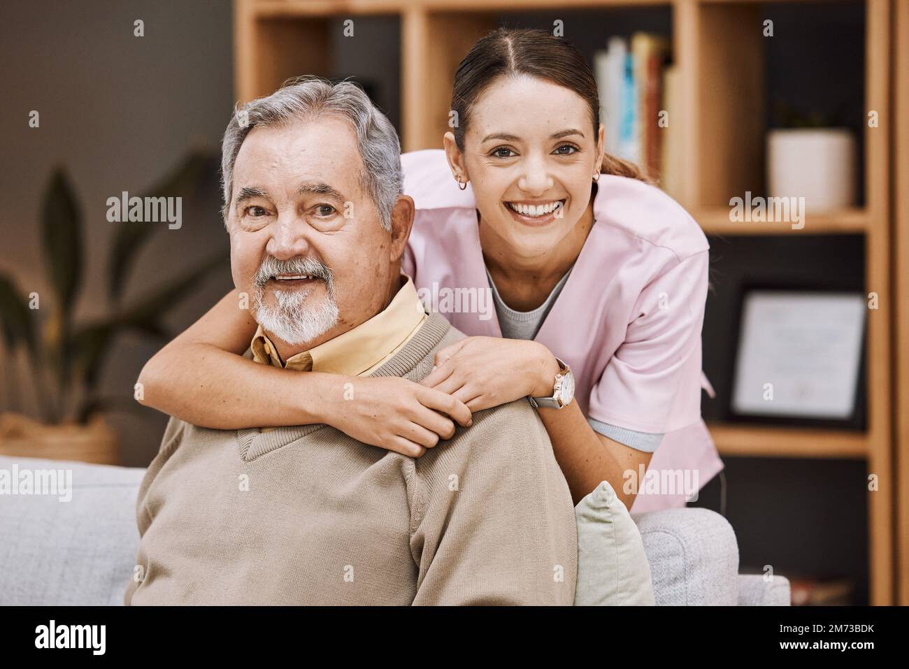 Healthcare, support and nurse with a senior man for medical attention, consulting and nursing from a house. Trust, hug and portrait of a caregiver Stock Photo