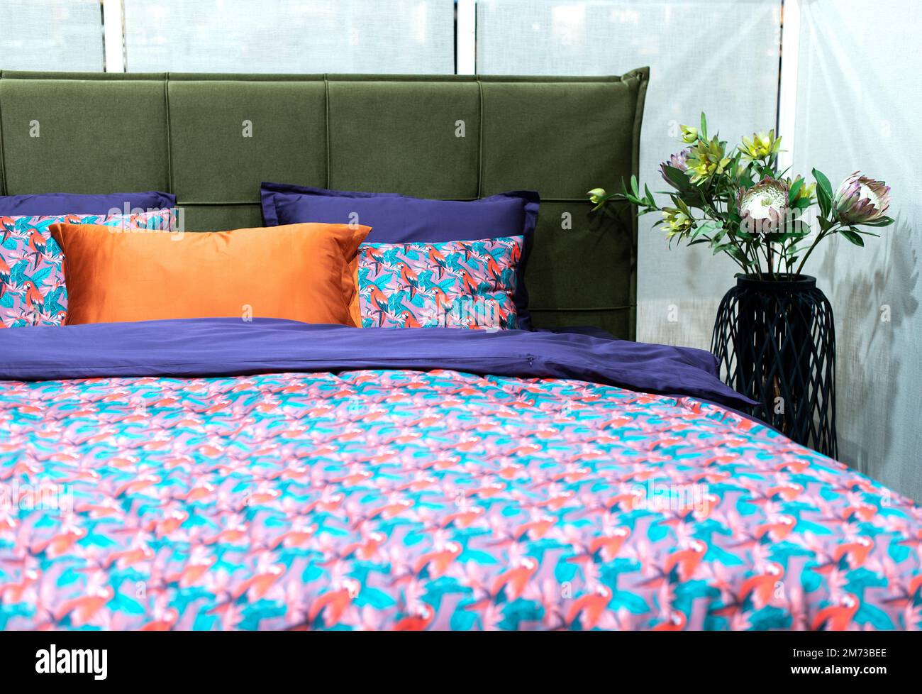 interior of modern bedroom with soft bed and multicolor pillows Stock Photo