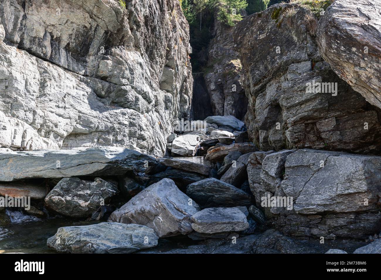 Lillaz waterfall (Cascate di Lillaz) bed, dried up this season, divided by thousands of years of formation in granite alpine rocks, Aosta valley Stock Photo