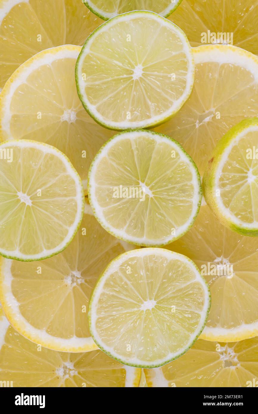 background of sliced lemons and limes for both alcoholis and non