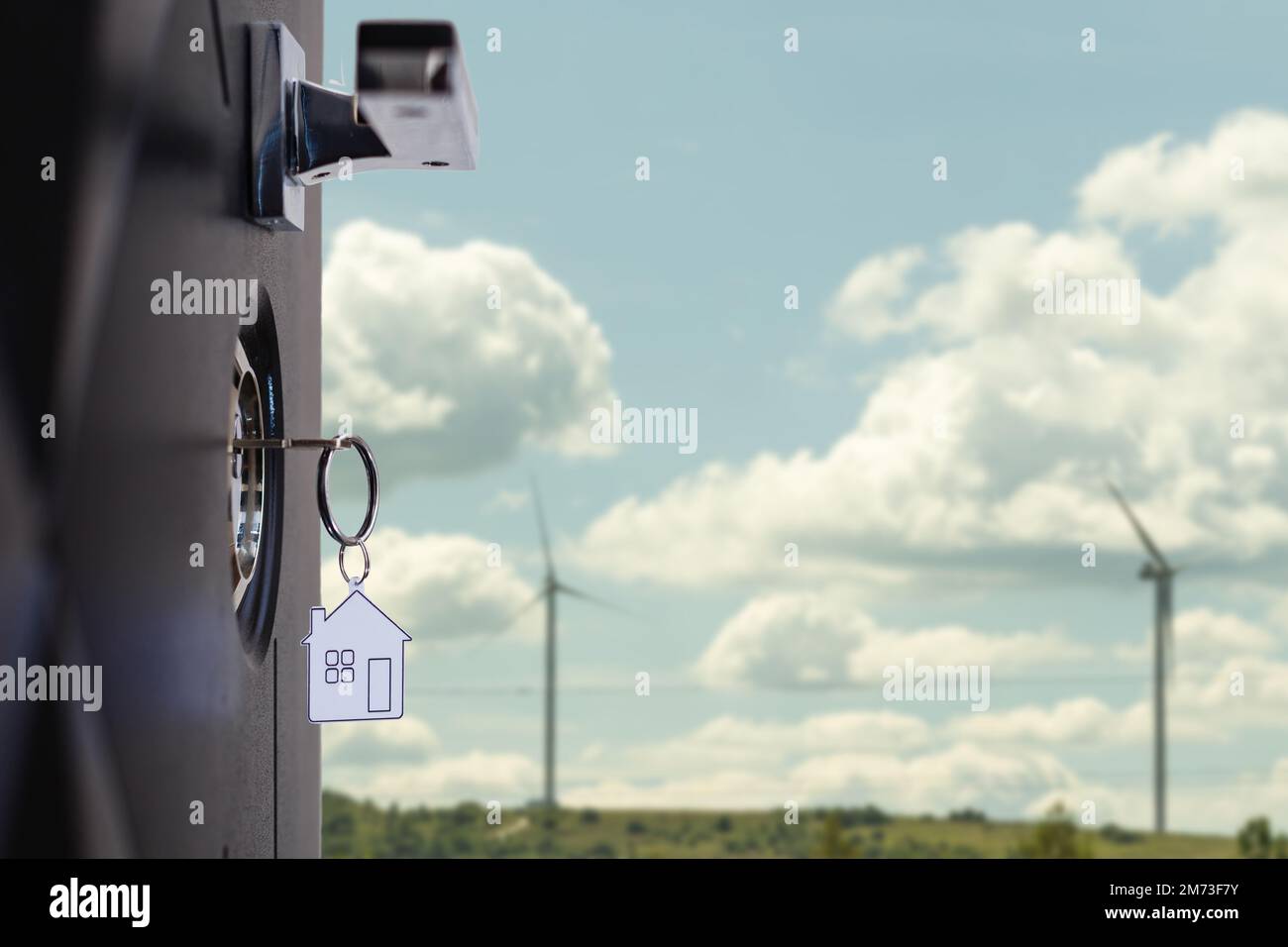 Opened door of a family home. Closeup of the lock with your keys on an