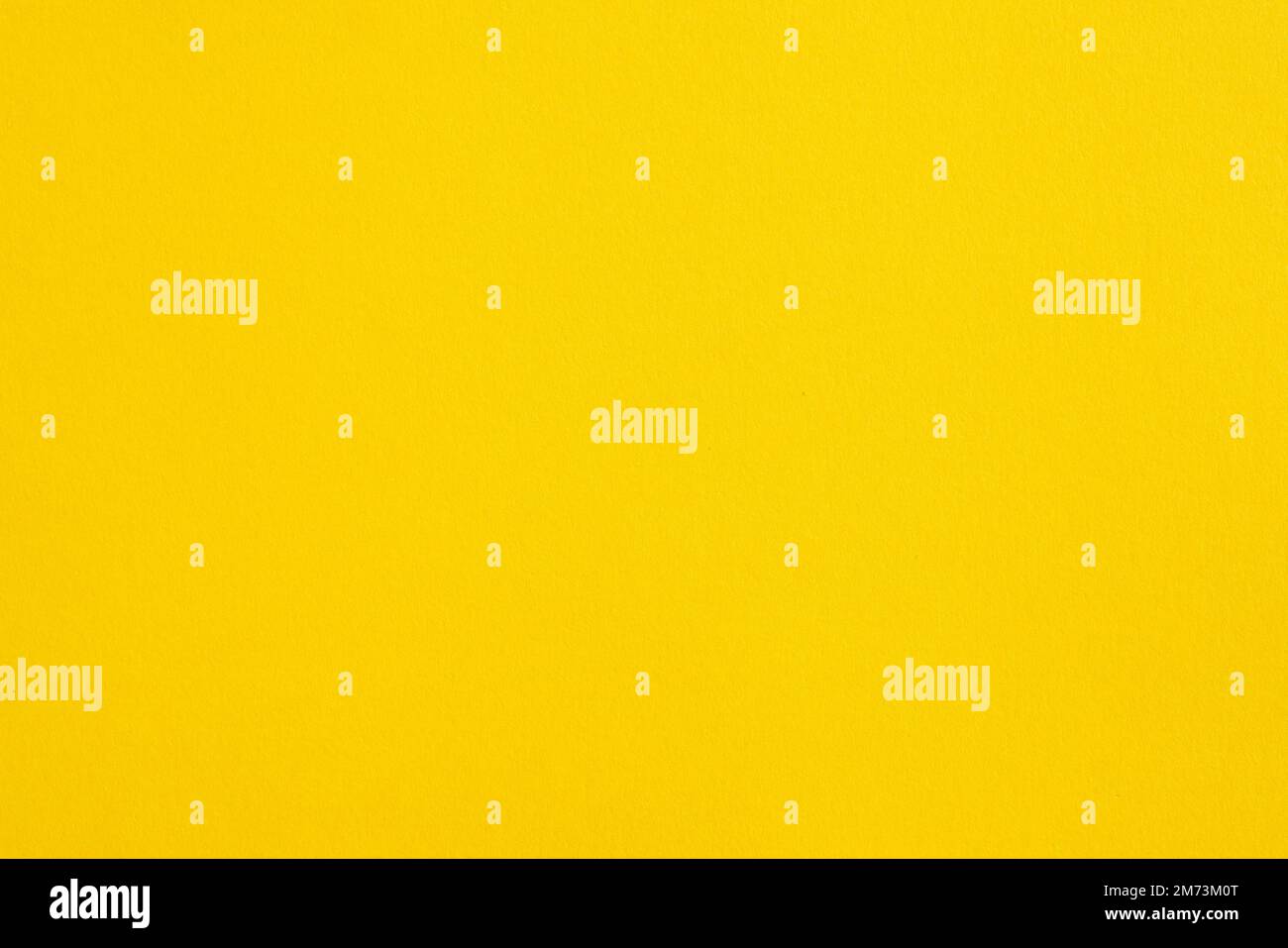 Closeup photo of cardboard sheet surface in solid yellow bright color