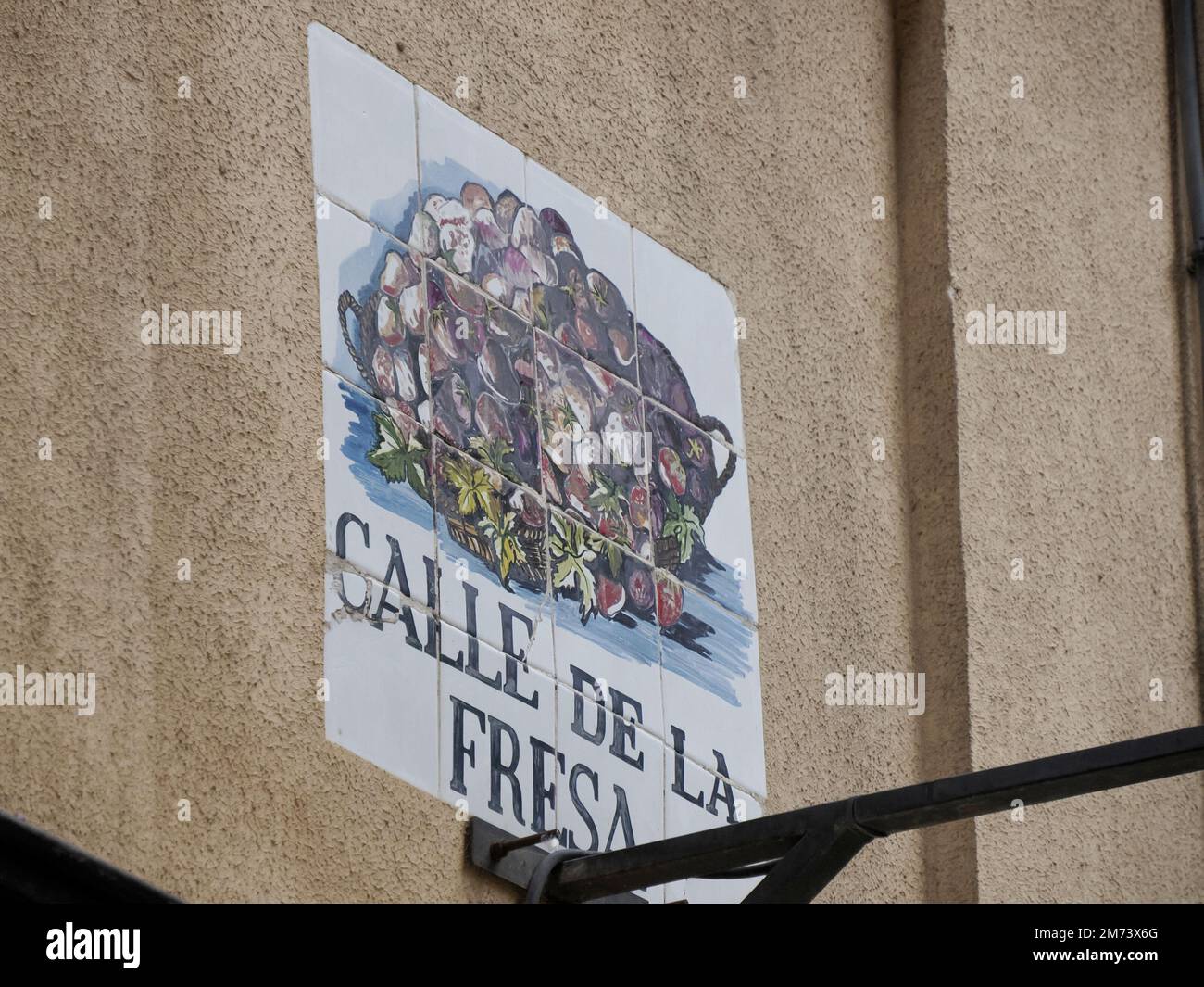 MADRID, SPAIN - DECEMBER 14, 2022: Street name calle de la fresa strawberry street sign on in Madrid, capital of Spain renowned for its rich repositor Stock Photo
