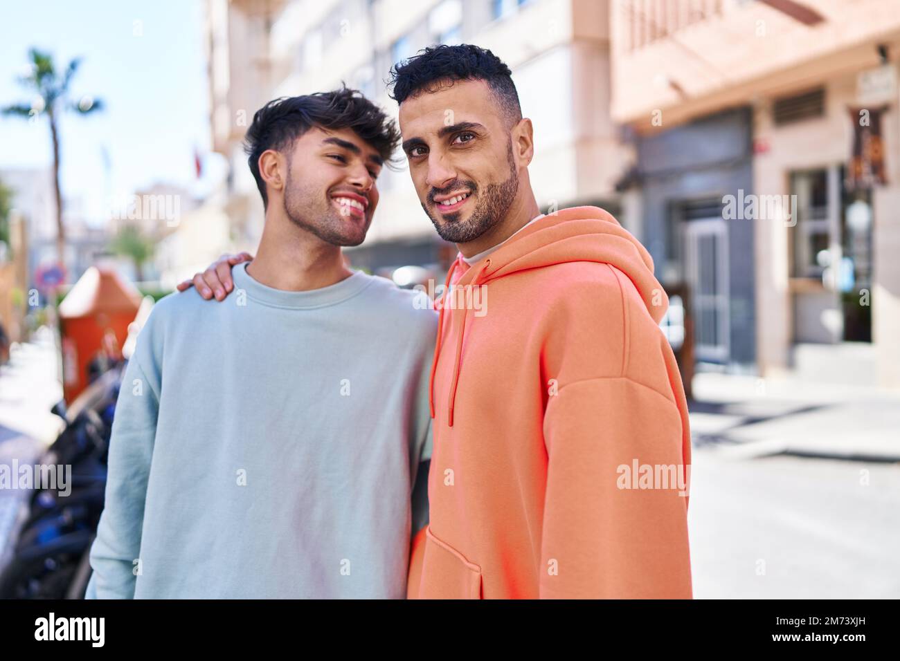 Two man couple hugging each other standing at street Stock Photo - Alamy