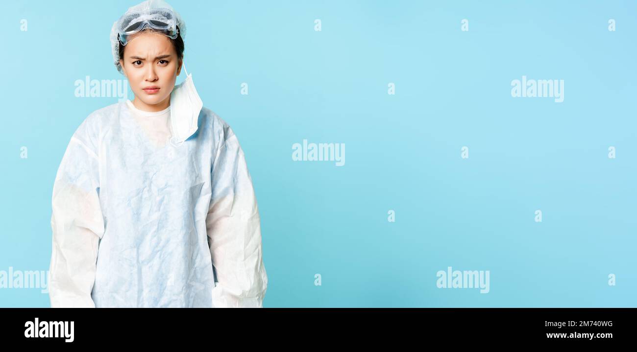 Angry asian woman doctor or nurse, wearing personal protective