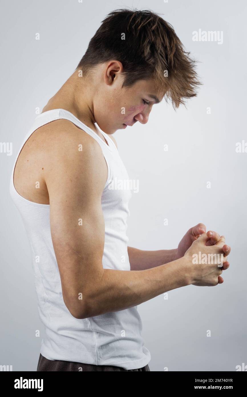 Young man in a white wife beater shirt Stock Photo - Alamy