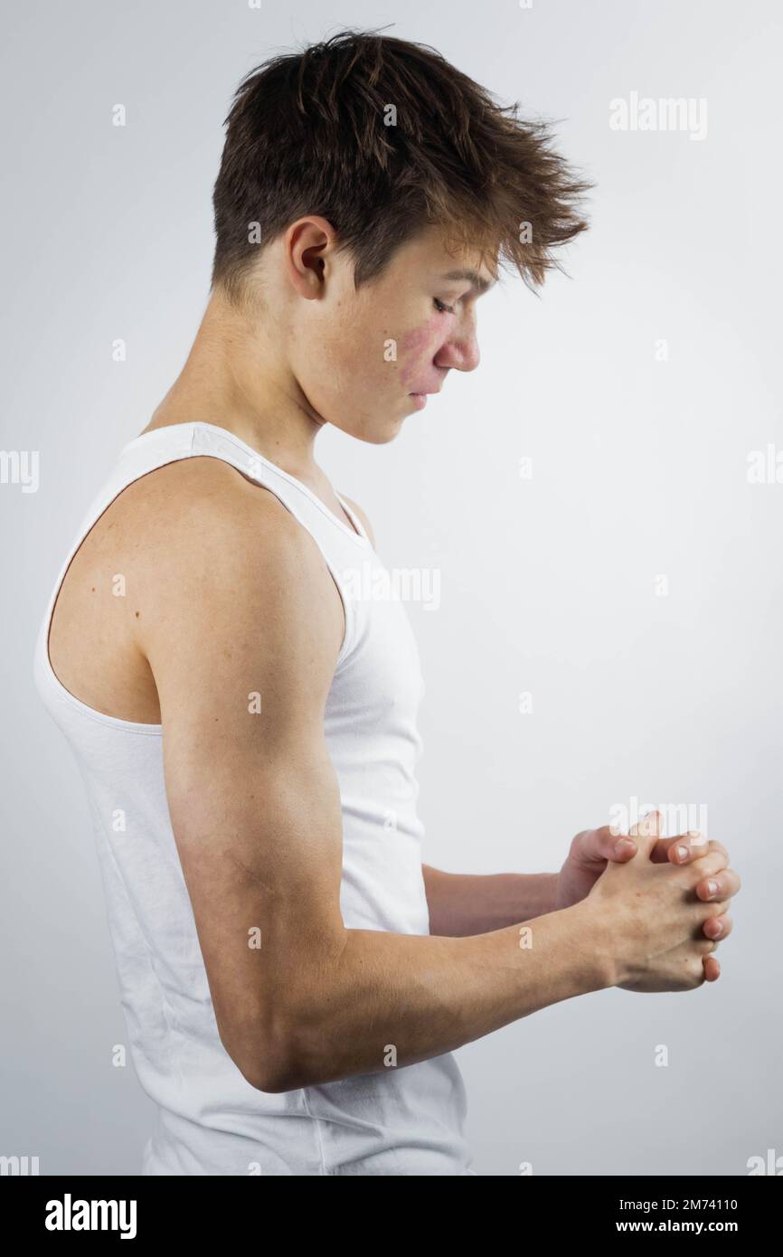 strong little boy in white tank top showing muscles with smile on his face  Stock Photo - Alamy