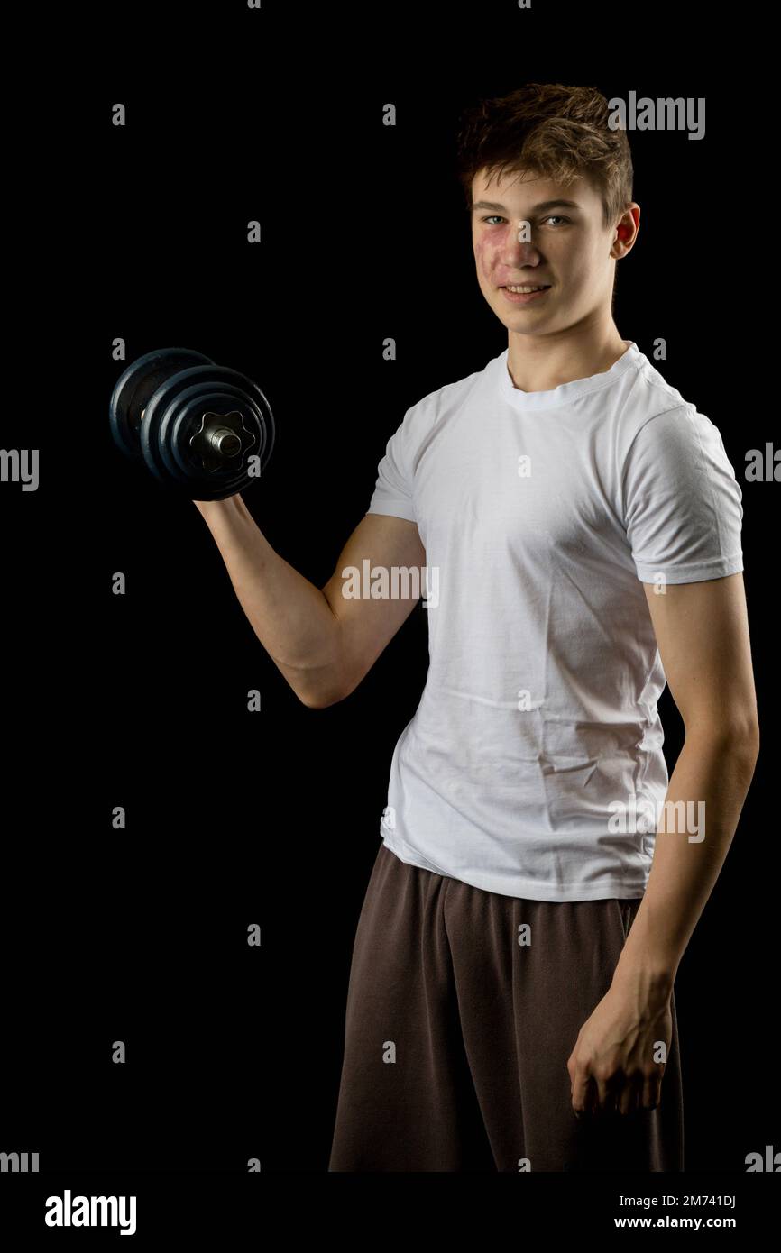 17 year olf teen boy using a dumbbell Stock Photo Alamy