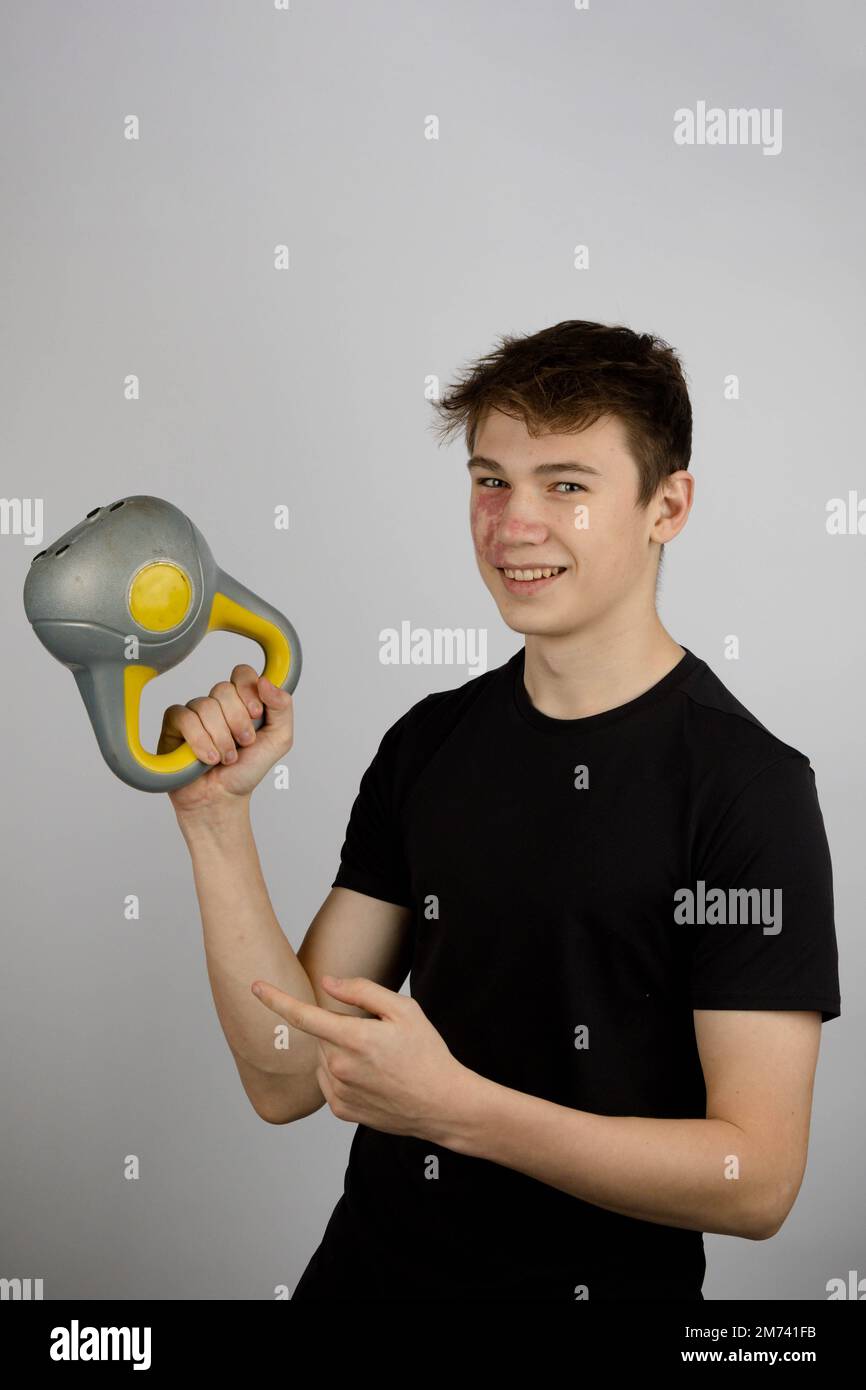 A Portrait of a 17 year old boy wearing a black tshirt using a