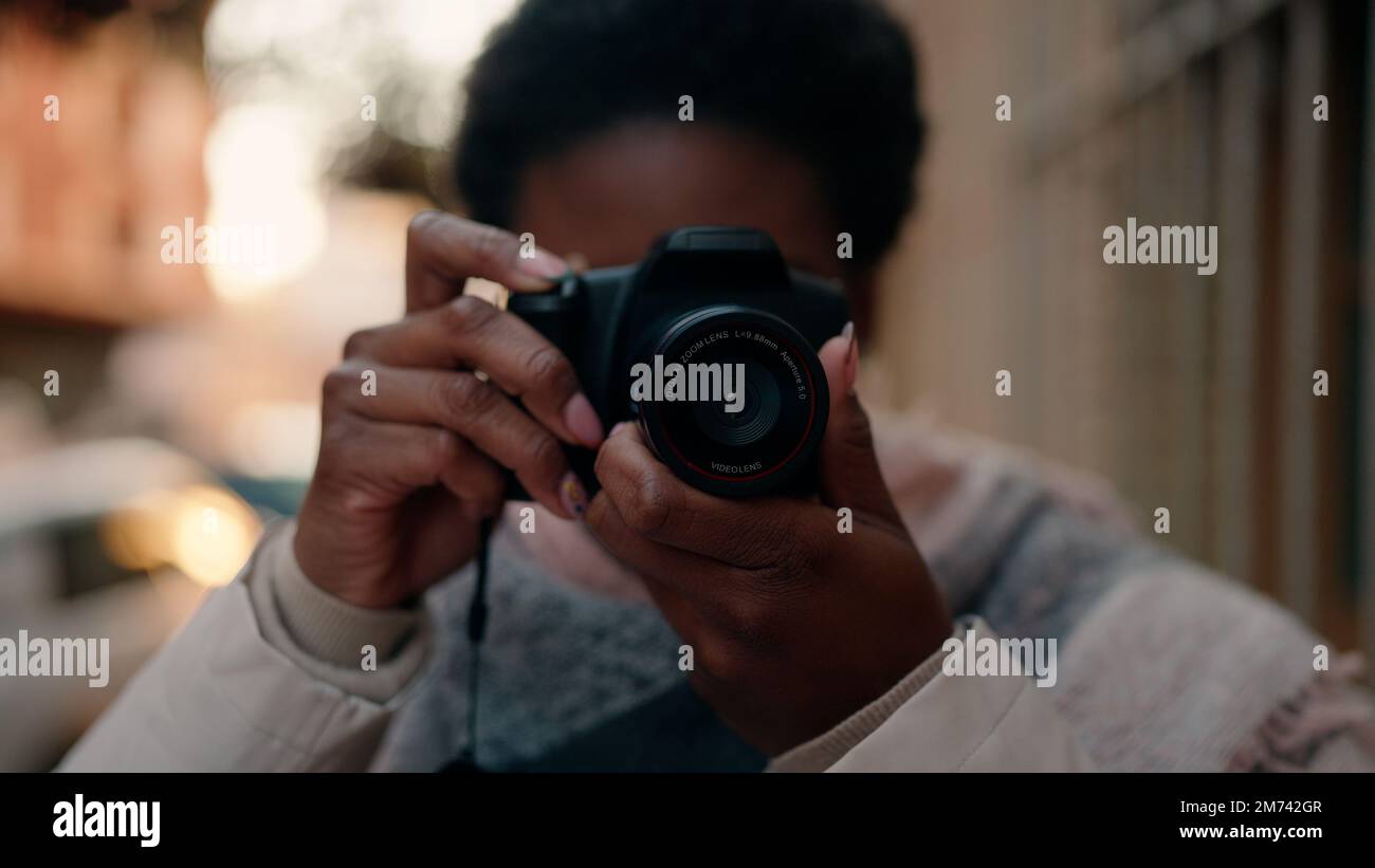 Young african american woman using professional camera at street Stock ...