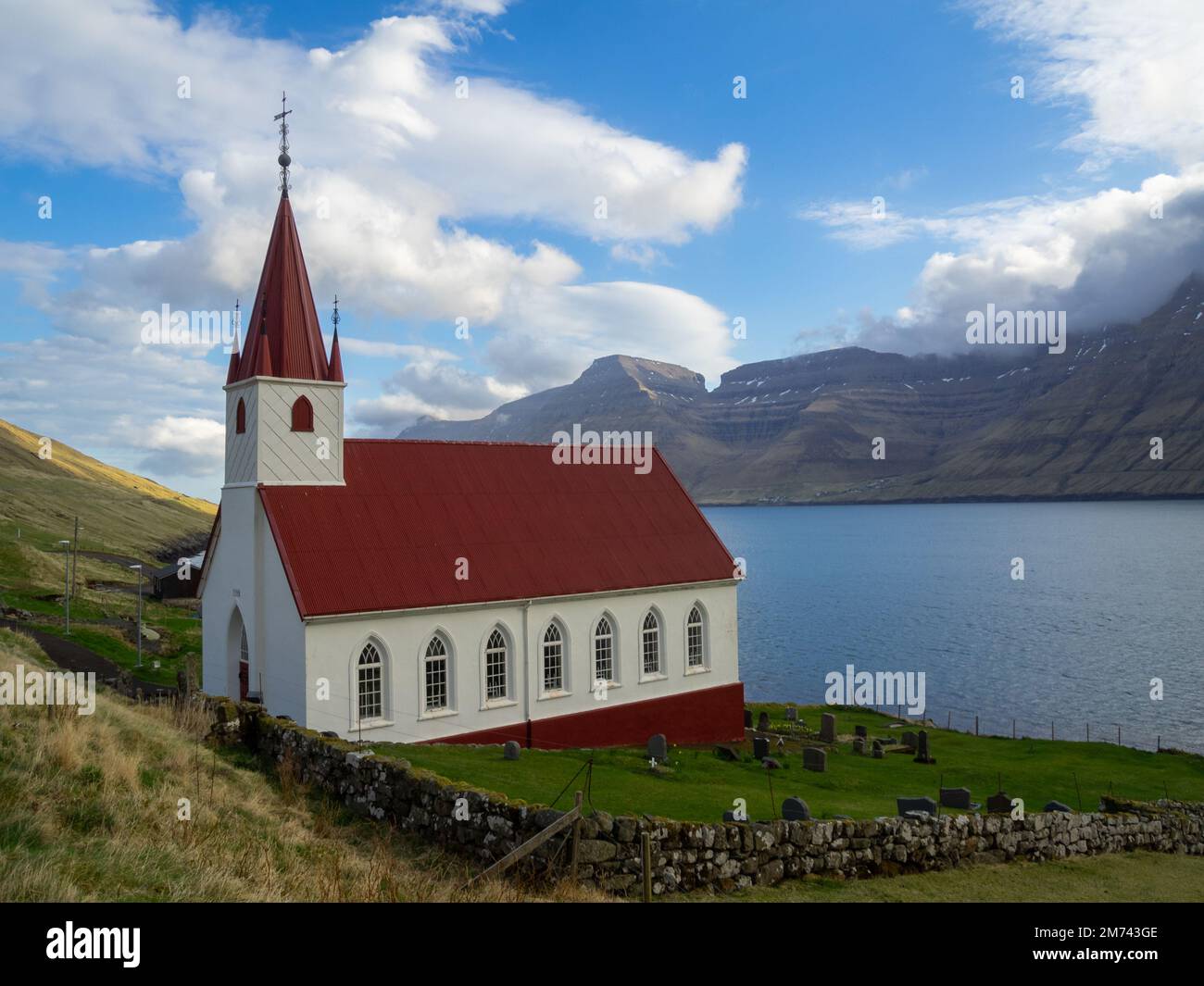 Húsar church by Kalsoyarfjørður fjord with Kunoy island in background Stock Photo