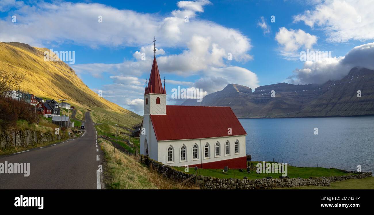 Húsar church by Kalsoyarfjørður fjord  and the road to the north Stock Photo