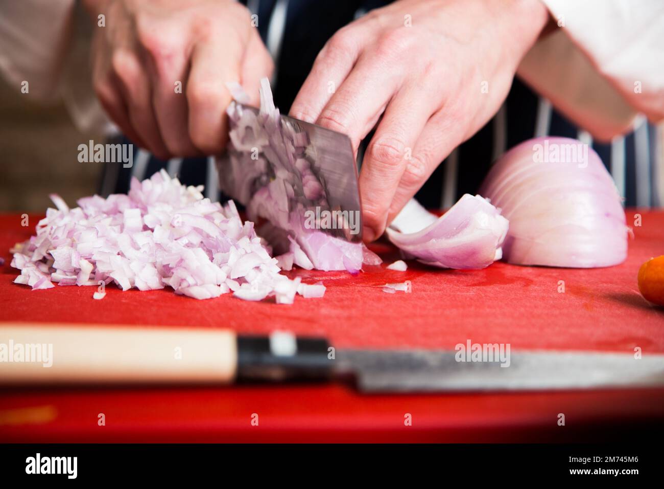 Professional chef cutting onion in a restaurant Stock Photo Alamy