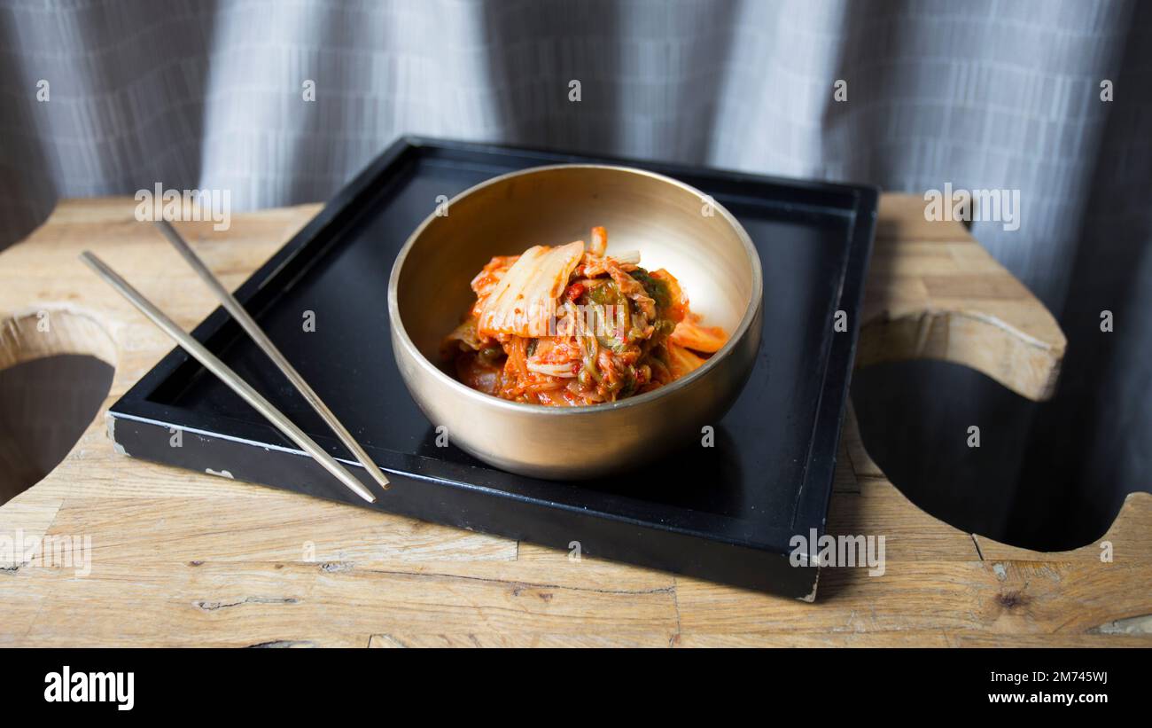 Bowl with kimchi salad. Kimchi is a Korean dish made from a fermented preparation whose basic ingredient is Asian cabbage or Brassica pekinensis cabba Stock Photo