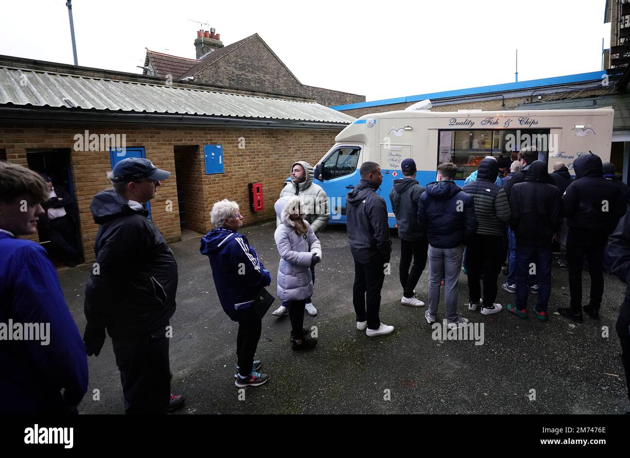 Fans queue at a fish and chips van during the Emirates FA Cup third ...