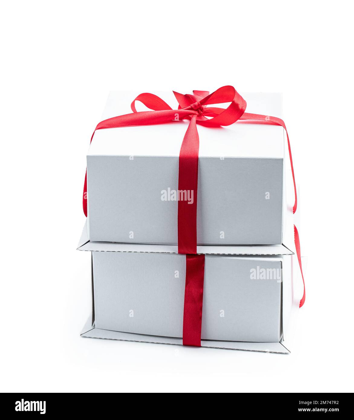 Stack of two gift boxes wrapped with red ribbon isolated on white Stock