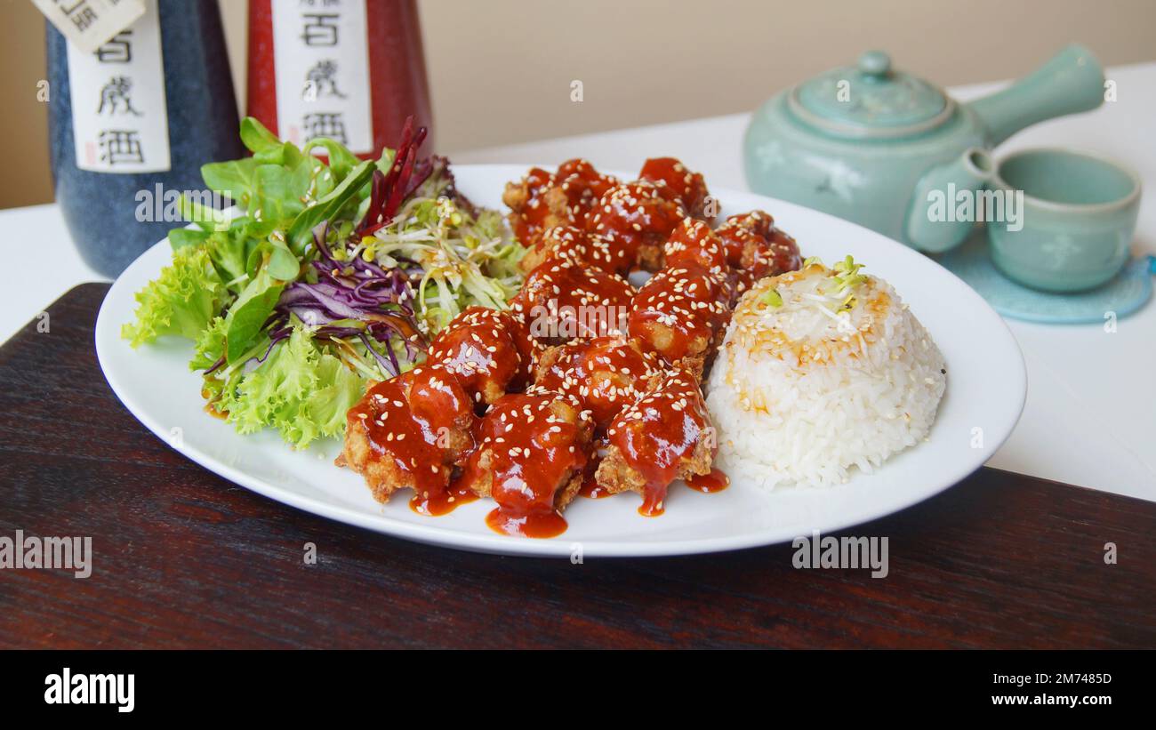 Asian combo plate with chicken balls covered with tomato sauce. Stock Photo