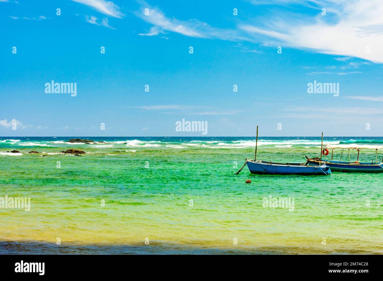 Boats on the waters of the paradisiacal beach of Itapua in the city of Salvador in Bahia Stock Photo