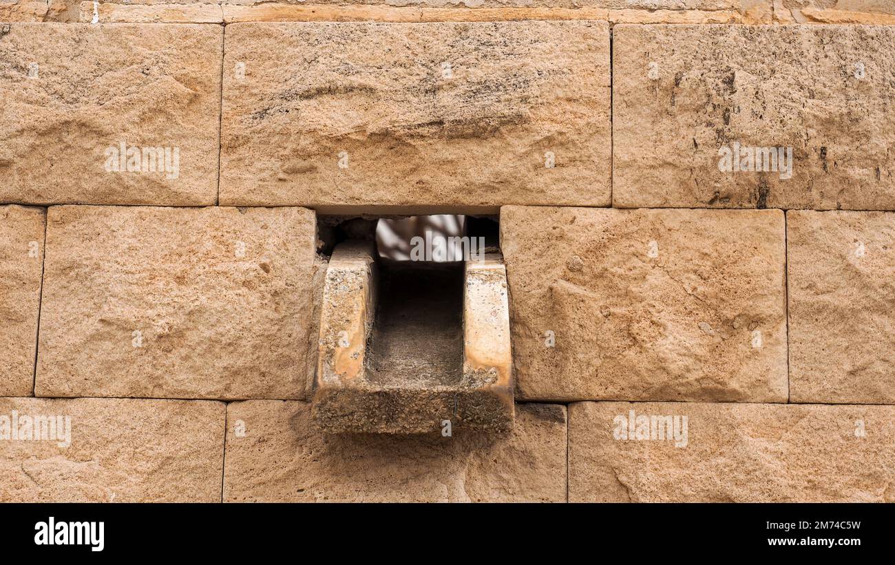 old stone drain in typical mallorquinischen limestone wall Stock Photo