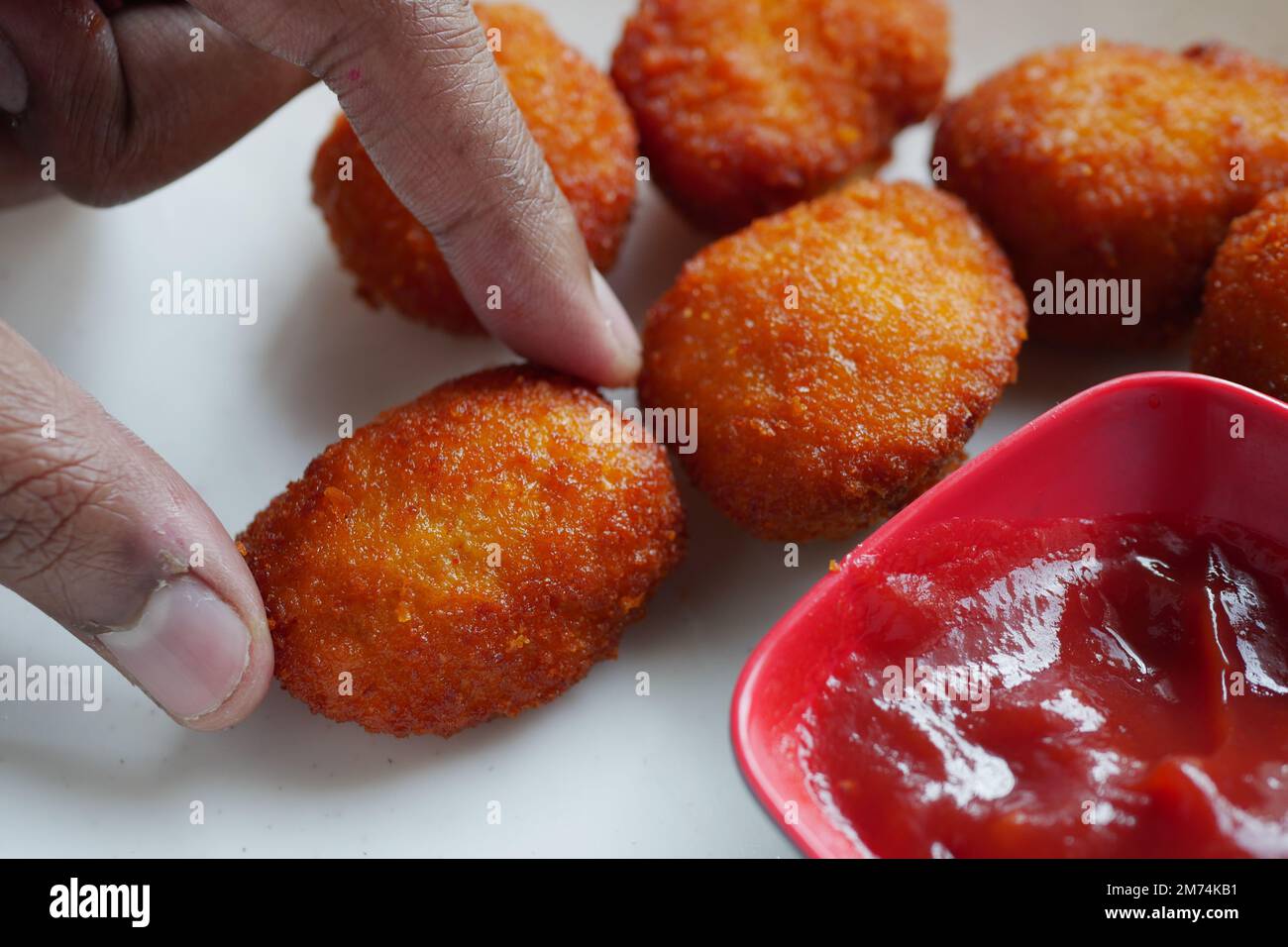close up of chicken nugget and sauce on table  Stock Photo