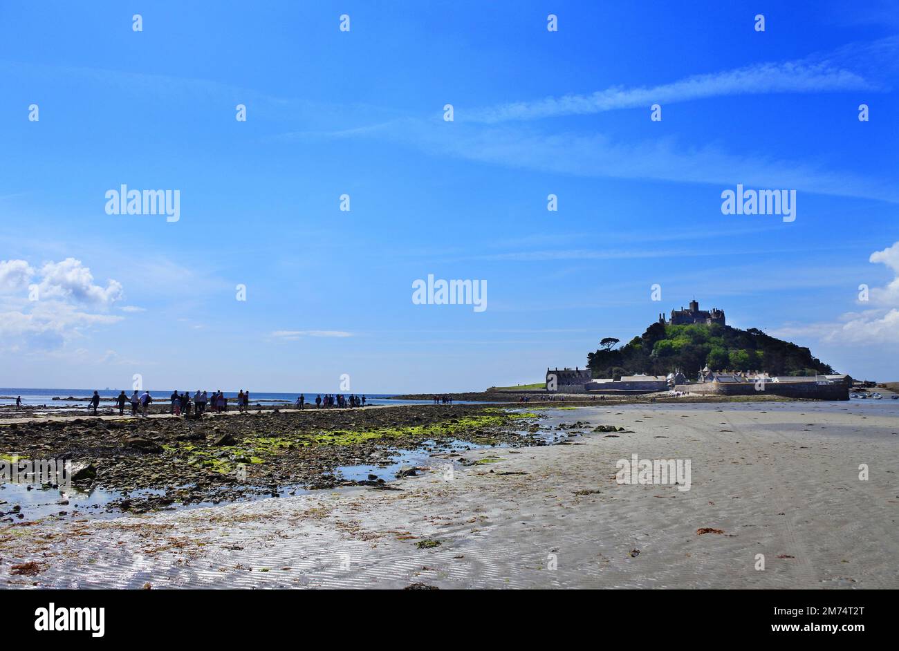 Tourists Making Their Way Over The Causeway At Low Tide To Visit St tourists-making-their-way-over-the-causeway-at-low-tide-to-visit-st