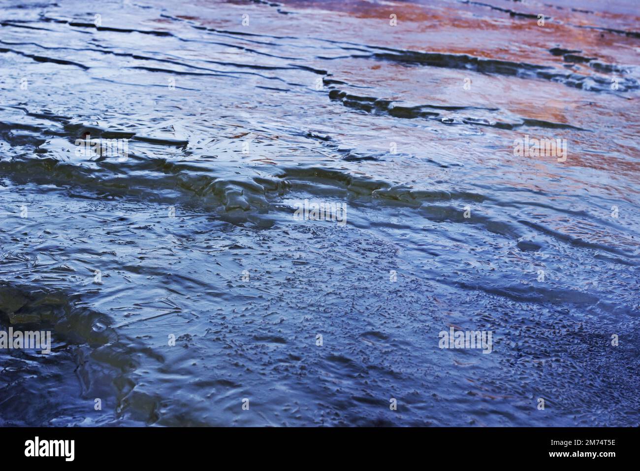 Dark Blue with Red Spots Frozen Waves of Wastewater Stock Photo