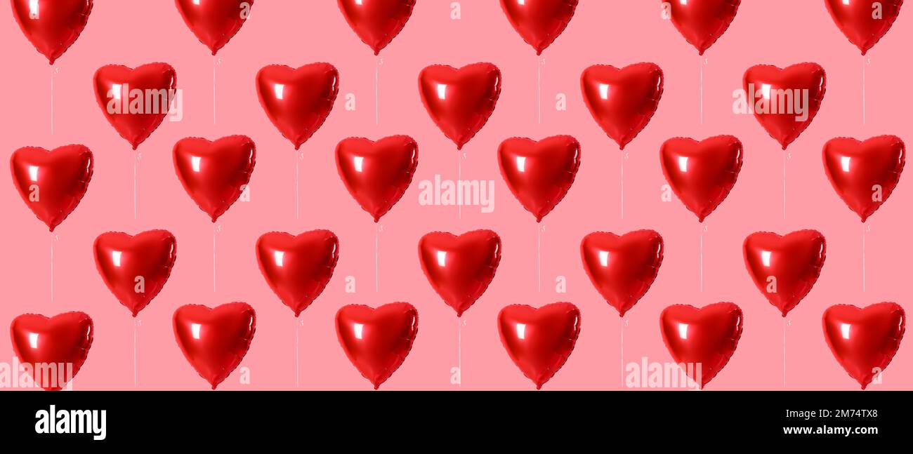 Many heart-shaped balloons on pink background. Patter for Valentine's Day Stock Photo