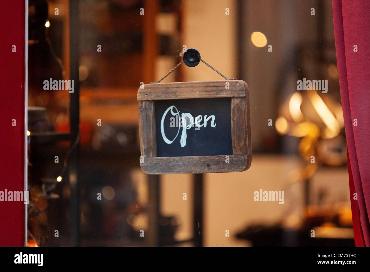 Small writing slate at the entrance of a restaurant saying : Open. Stock Photo