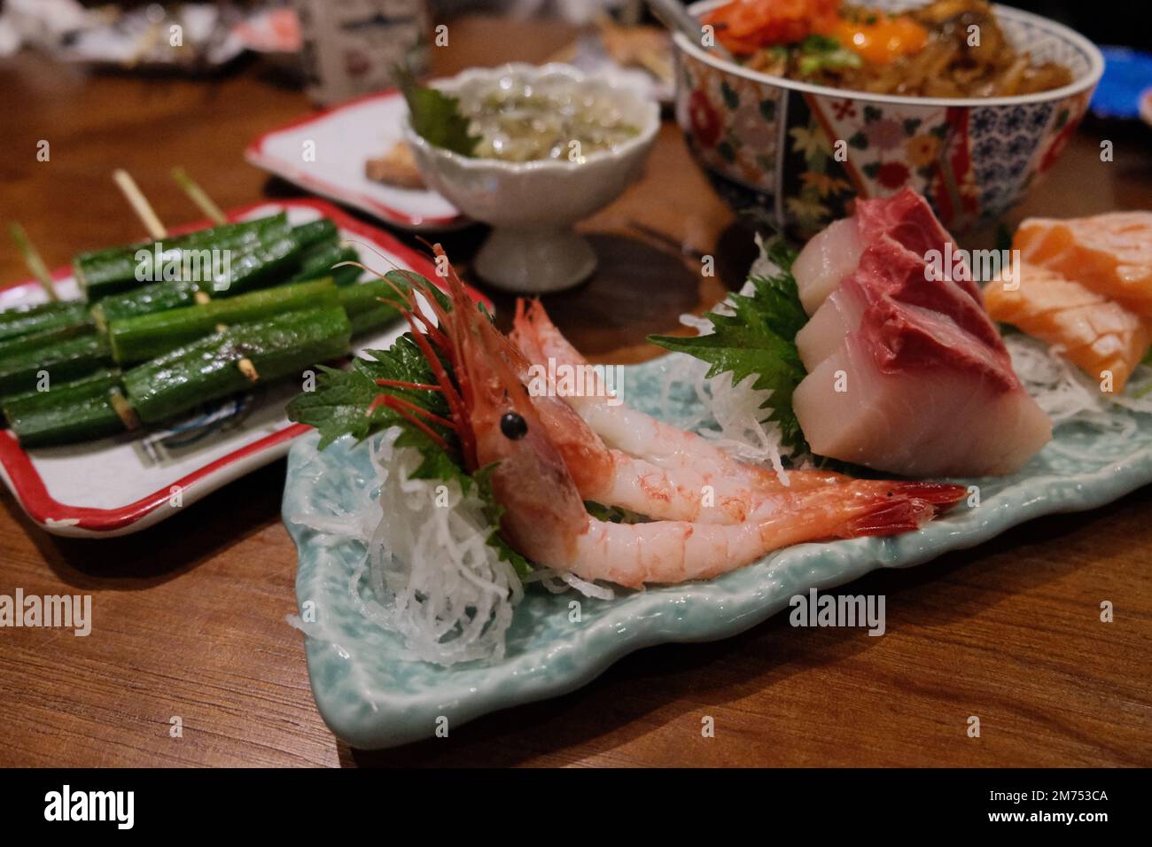 A closeup of traditional Japanese Sashimi on a wooden table Stock Photo ...