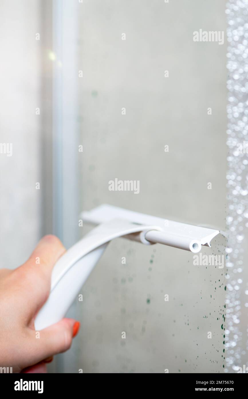 Shower cabin cleaning. Cleaning glass after using the shower. Cleaning