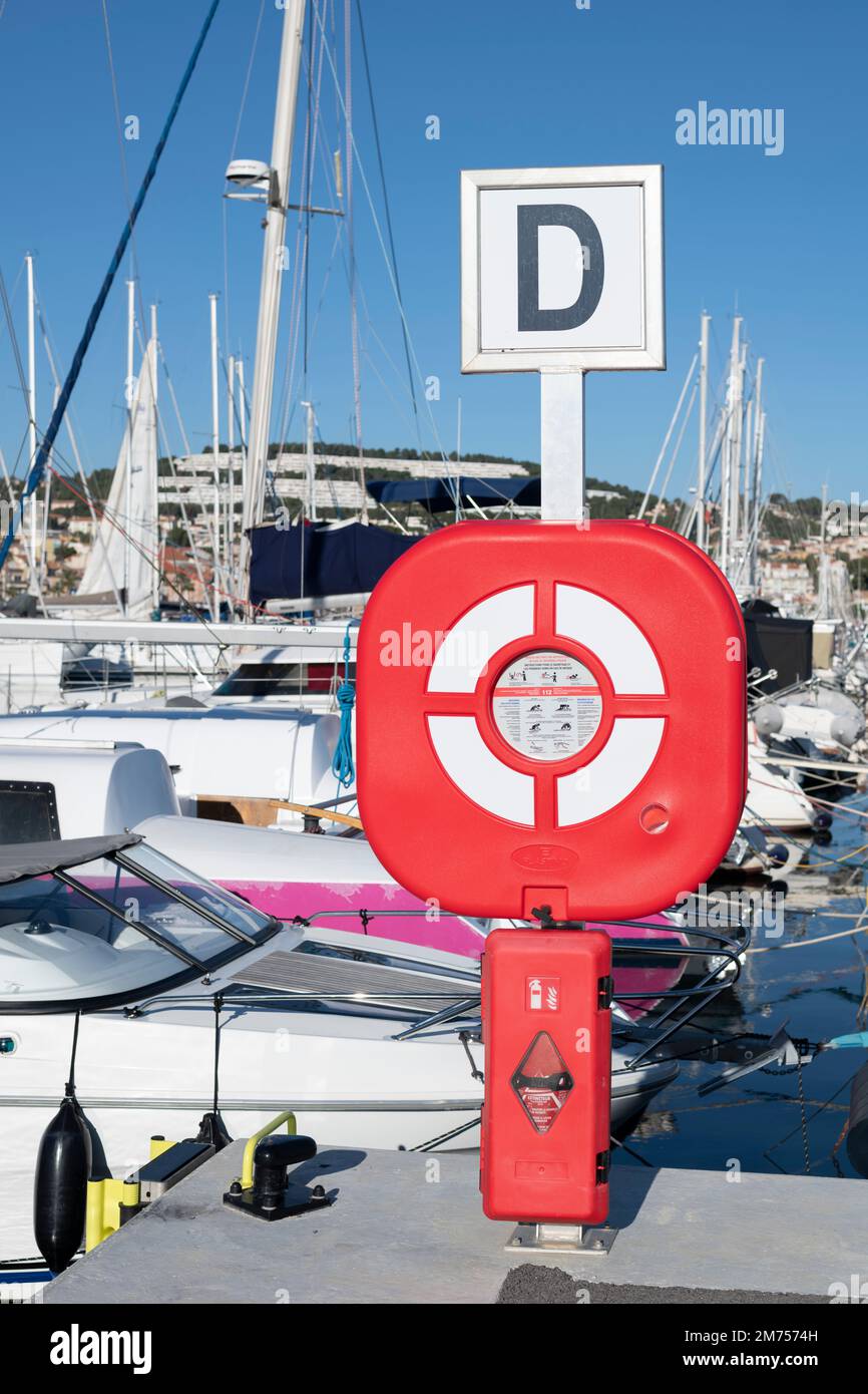 Life Ring Station and Fire Extinguisher Cabinet at the marina of Bandol, South of France Stock Photo