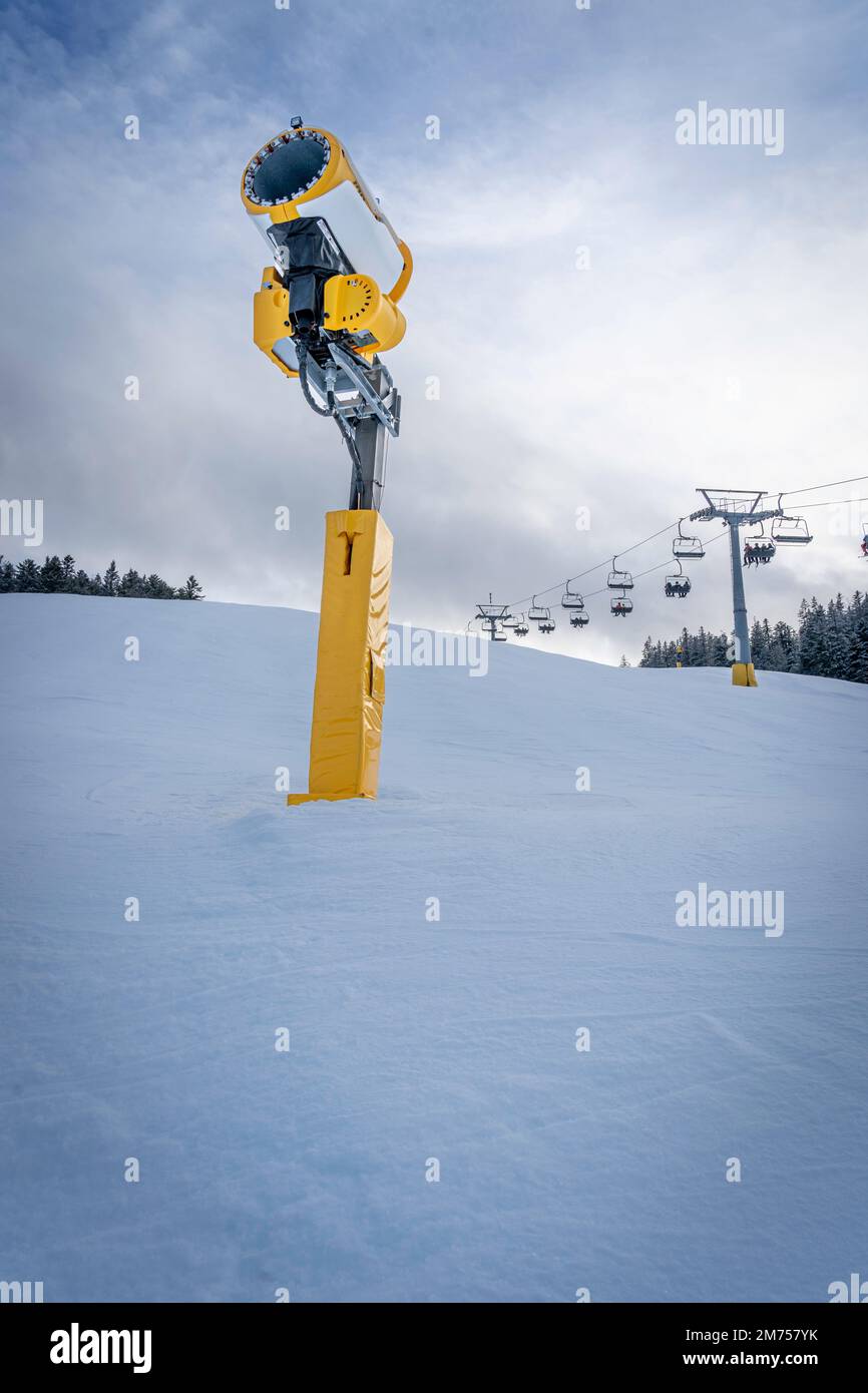 Artificial snow cannons (snow gun) at ski slope in the Alps, Austria. These machines are used to compensate for low snowfall by producing artificial s Stock Photo