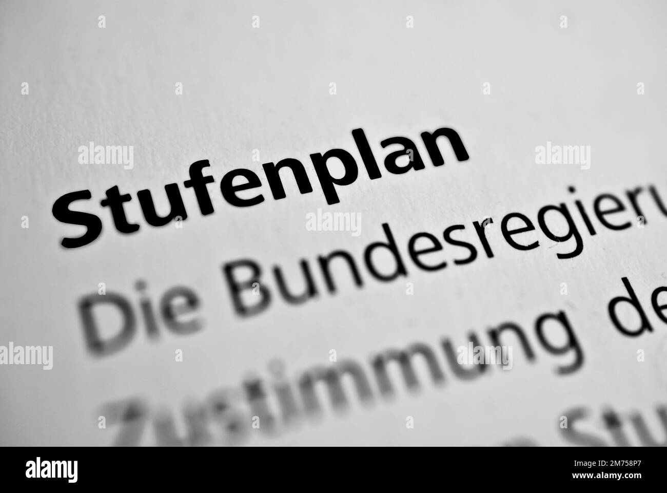 A closeup of the german word Stufenplan written in bold font surrounded