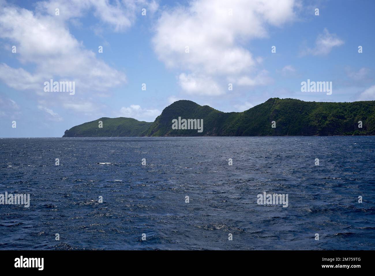 A landscape view of the sea with green hills on the beach on a sunny ...