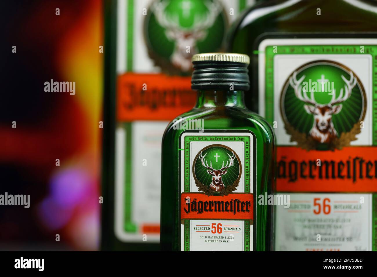 KYIV, UKRAINE - MAY 4, 2022 Jagermeister original alcohol bottle on wooden table with red fireplace on background. Elite alcohol production Stock Photo