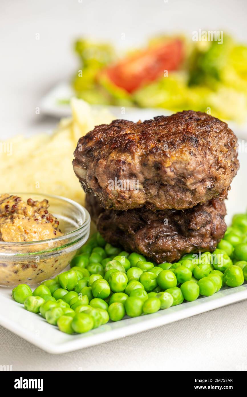 bavarian meat loafs with peas Stock Photo
