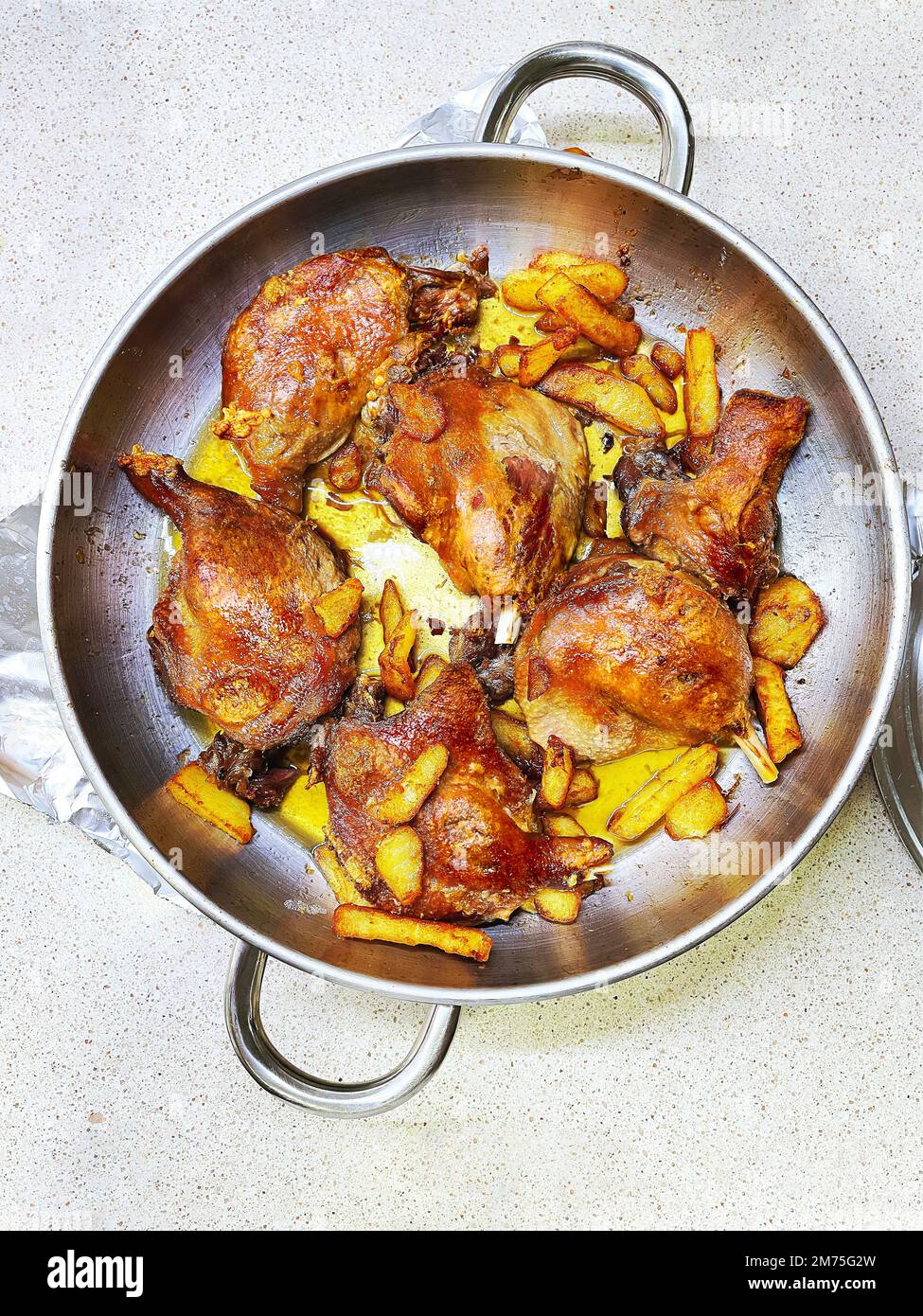 Confit de Canard with a side of fries, a traditional French dish made from duck legs. Stock Photo