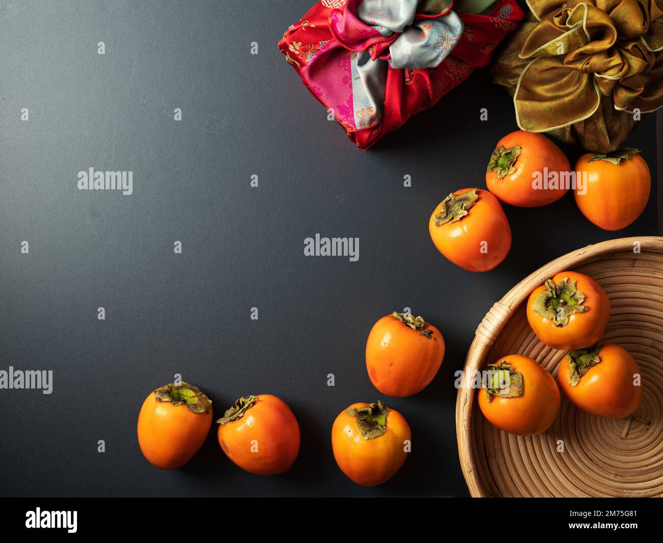 Korean traditional gift with persimmons on dark background Stock Photo